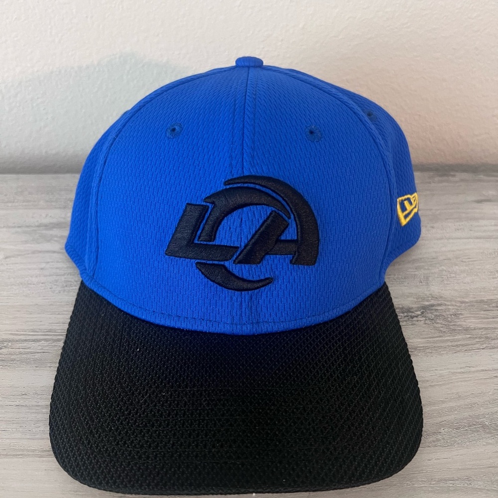 La rams football New Era Blue and Black Cap never worn. Too small for my head.